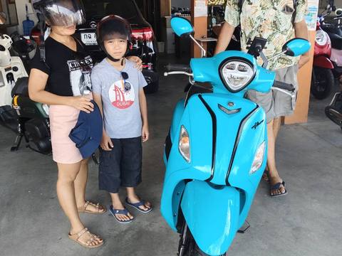 Customer with scooter near the coast