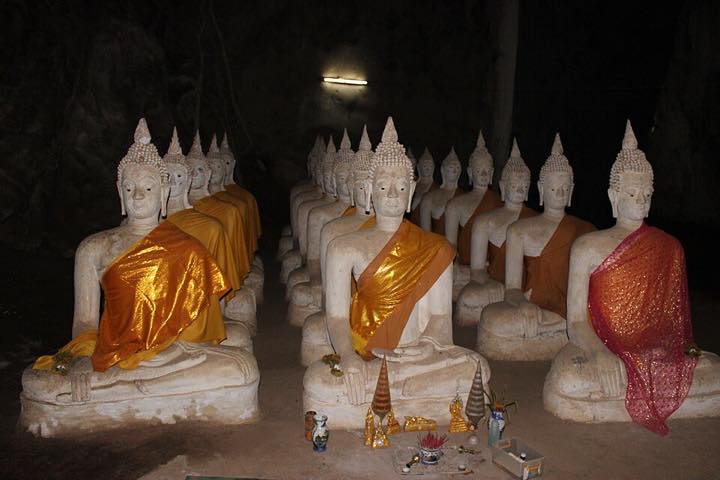 Rows of Buddha statues inside the cave at Wat Ao Noi